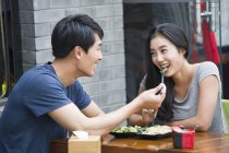 Chinese couple eating lunch at restaurant — Stock Photo