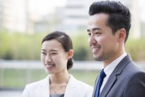 Chinese business people looking at view and smiling — Stock Photo