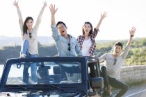 Chinese friends having fun in car — Stock Photo