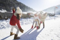 Crianças chinesas da idade elementar brincando na neve na aldeia — Fotografia de Stock