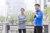 Mature chinese couple resting after exercising — Stock Photo