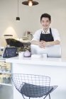 Chinese coffee shop owner at counter — Stock Photo