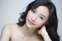 Portrait of beautiful chinese woman tilting head — Stock Photo