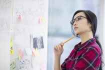 Chinese female designer working in office — Stock Photo