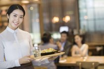 Китайская официантка, обслуживающая ресторан — стоковое фото
