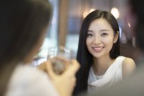 Chinese woman having dinner with friends — Stock Photo