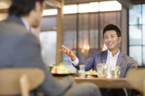 Chinese businessmen having dinner in restaurant — Stock Photo
