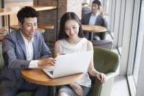 Chinesische Geschäftsleute arbeiten mit Laptop im Café — Stockfoto