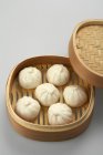 Dim sum in steamer basket with cover on white background — Stock Photo