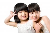 Portrait of two little Chinese girls on white background — Stock Photo