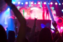 People silhouettes with illuminated stage, music festival in Beijing, China — Stock Photo