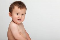 Studio shot of a cute Chinese baby boy looking at the camera — Stock Photo