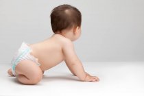 Studio shot of a cute Chinese baby boy looking away — Stock Photo