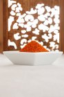 Square bowl of chili pepper spice, close up shot — Stock Photo