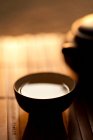 Tea cup and pot on bamboo mat, close up shot — Stock Photo