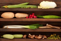 Various fresh vegetables on wooden shelf — Stock Photo