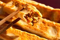 Chinese traditional dessert, sweet cake in chopsticks — Stock Photo