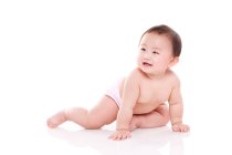 Studio shot of cute Chinese baby sitting on floor — Stock Photo