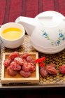 Chinese traditional preserved fruit and tea — Stock Photo