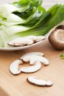 Bok choy and mushrooms on wooden surface — Stock Photo
