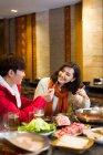 Junges chinesisches Paar beim Abendessen im Hotpot-Restaurant — Stockfoto