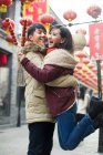 Young Chinese couple with candied haw berries celebrating Chinese New Year — Stock Photo