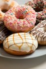Delicious donuts with various glaze and sprinkles — Stock Photo