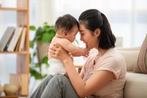 Portrait of young mother and cute baby — Stock Photo