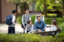 Teacher and students on campus — Stock Photo