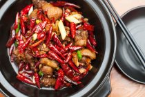 Chinese cuisine, beef with chili in bowl, close up shot — Stock Photo