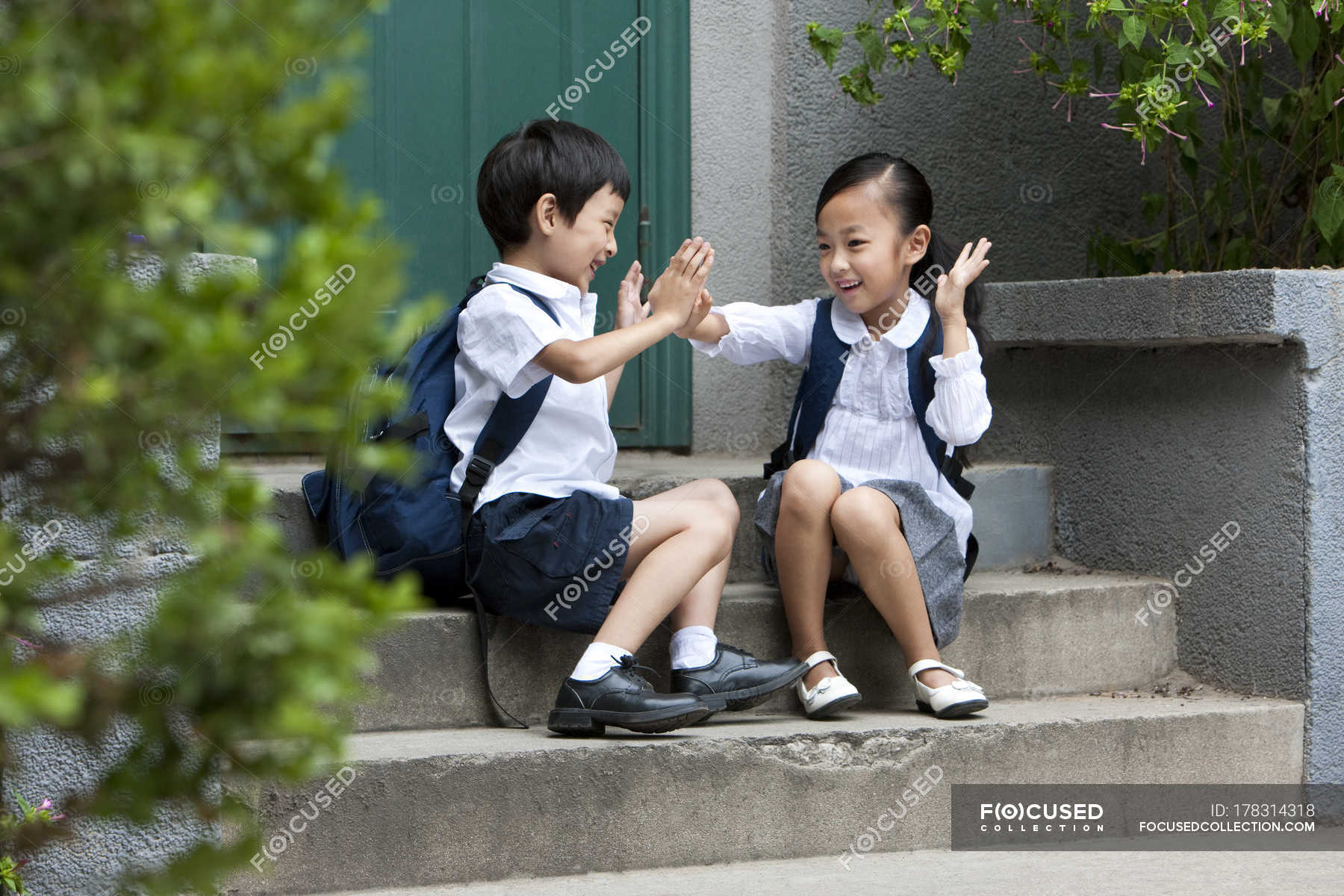 chinese-school-children-playing-on-steps-carrying-elementary