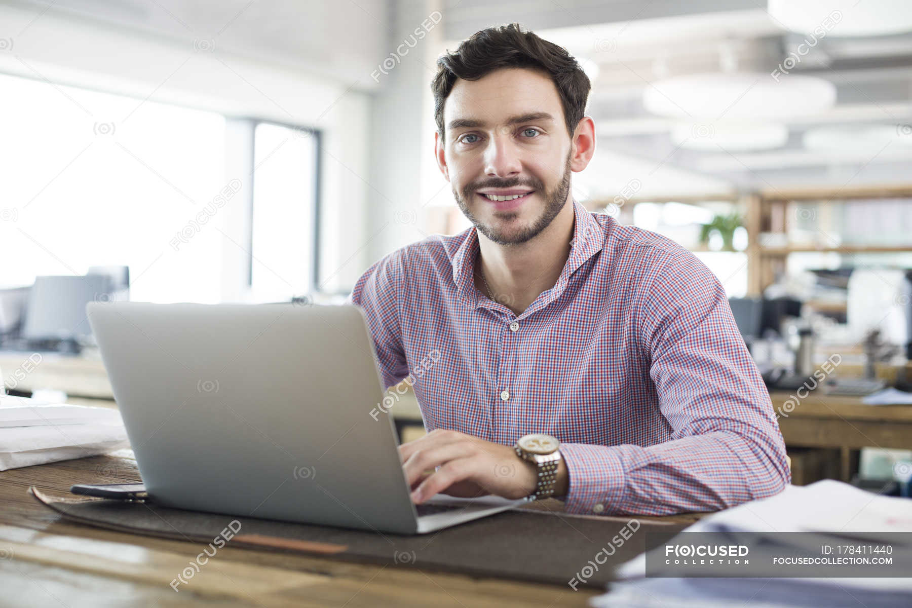 Male office worker working with laptop in office — technology, project