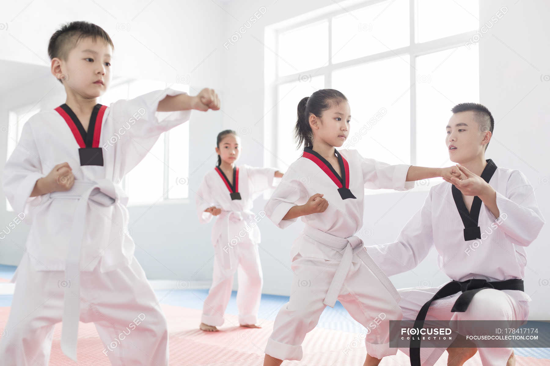 chinese-instructor-teaching-children-taekwondo-workout-activity