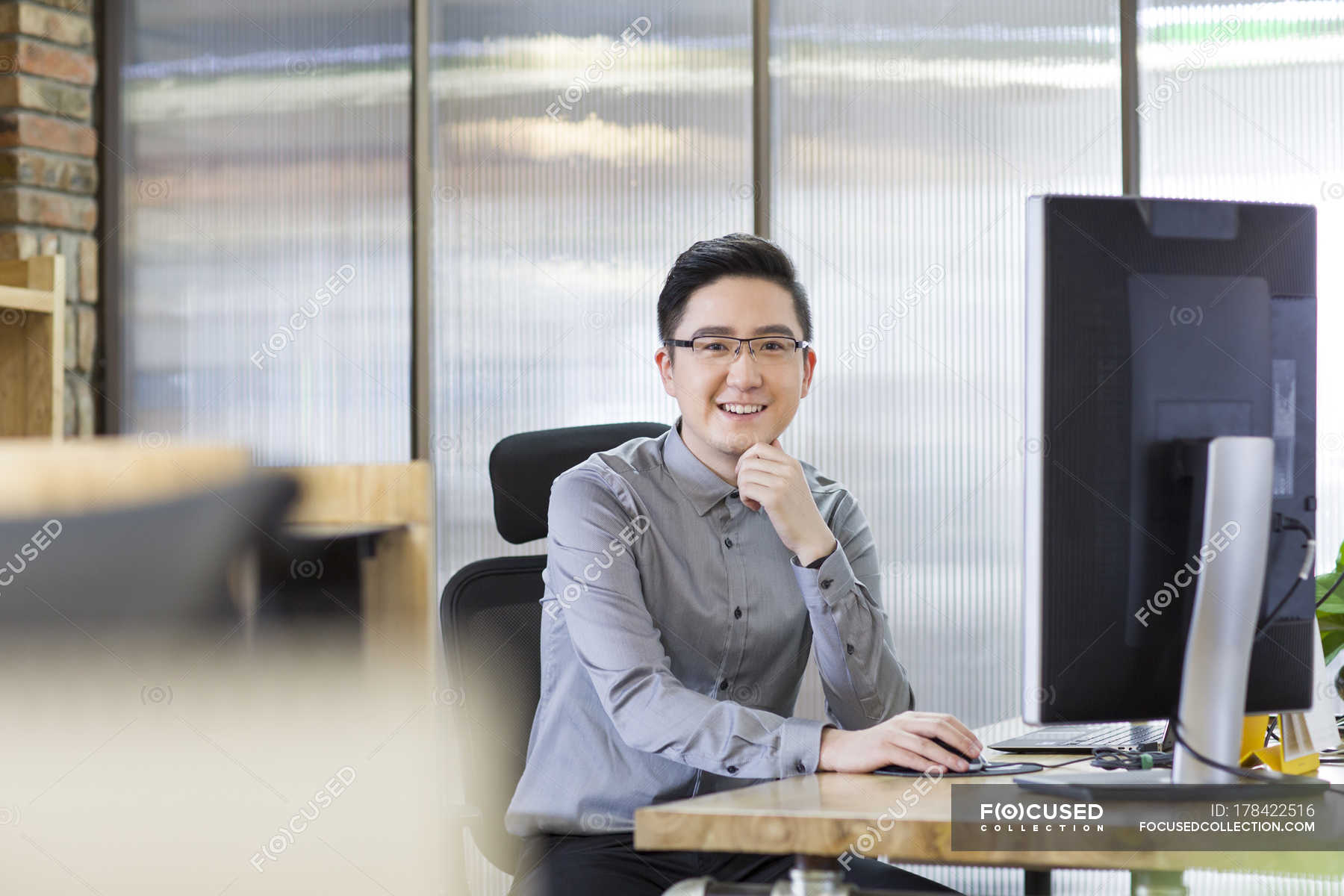 chinese-office-worker-sitting-in-office-people-male-stock-photo