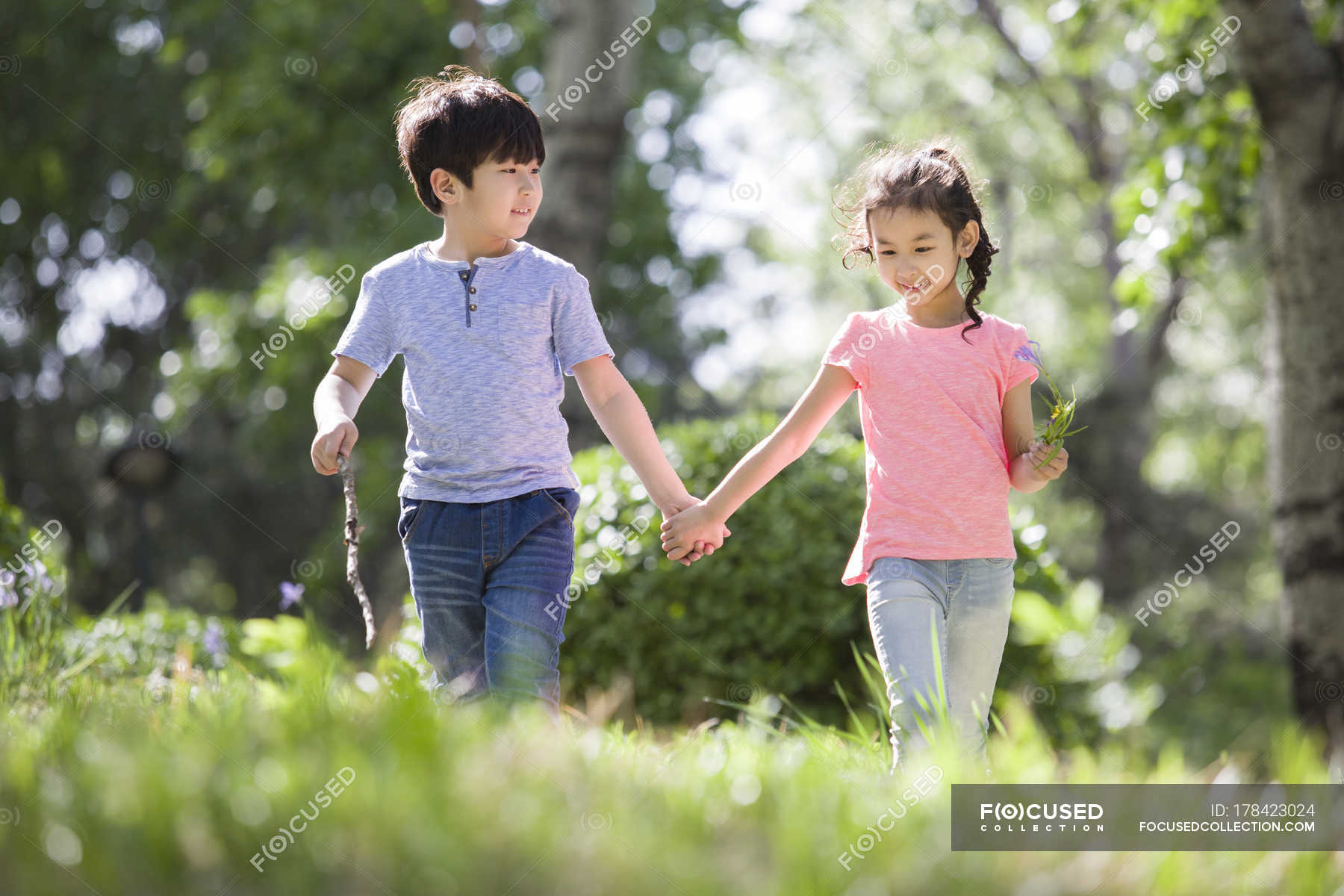 Chinese Boy And Girl Holding Hands Walking In Woods Forest Kids Stock Photo