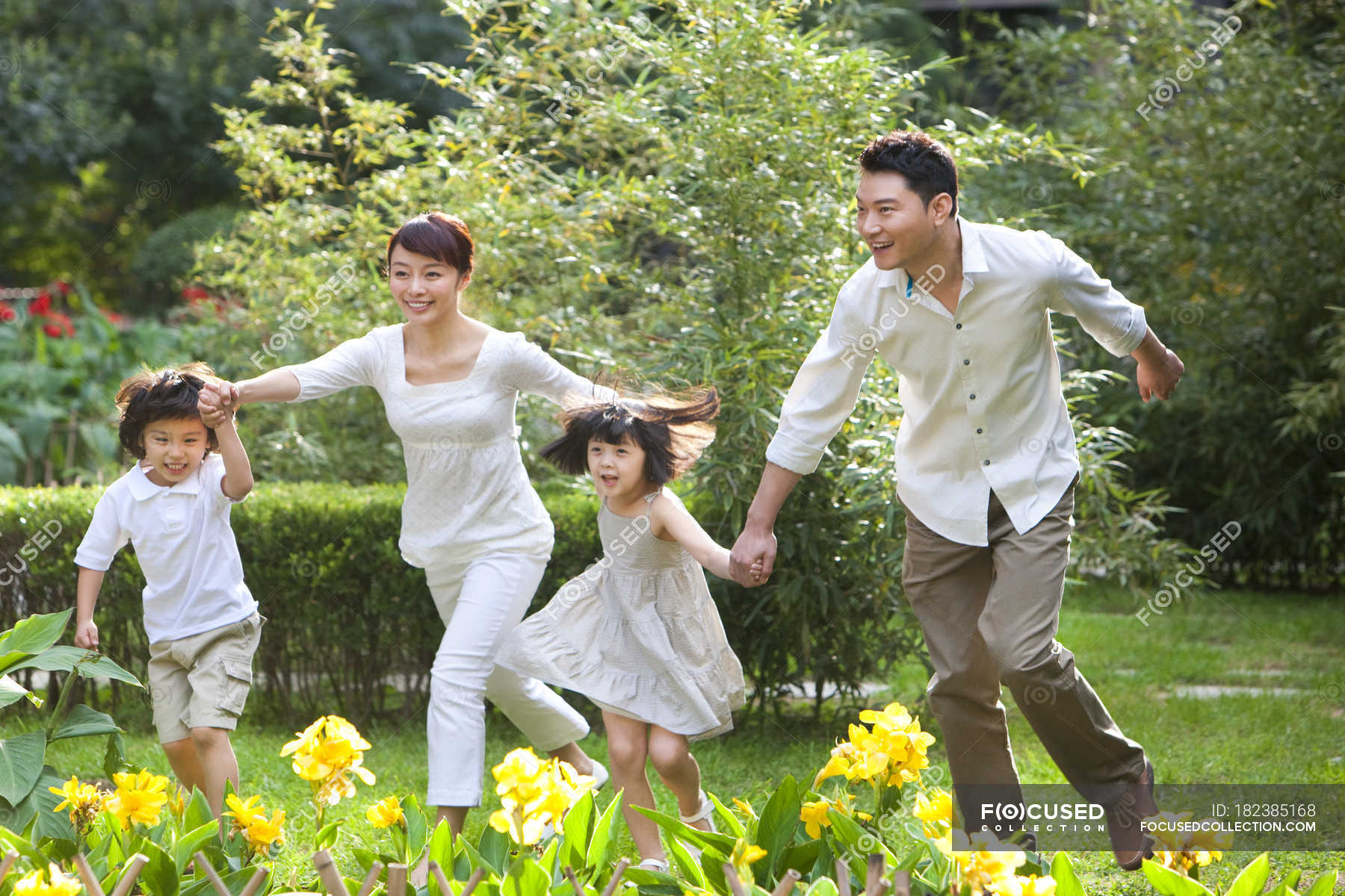 Chinese Family Running And Having Fun In Garden Mother People