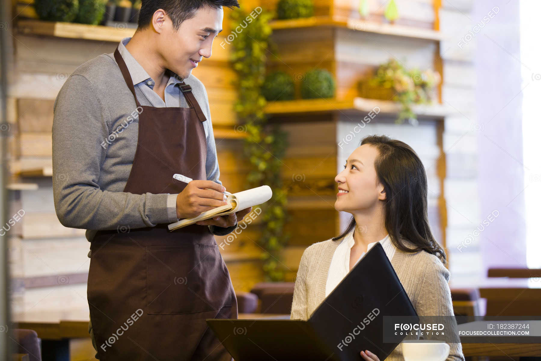 Chinese Waiter Taking Order From Woman At Restaurant — Indoor Scene ...