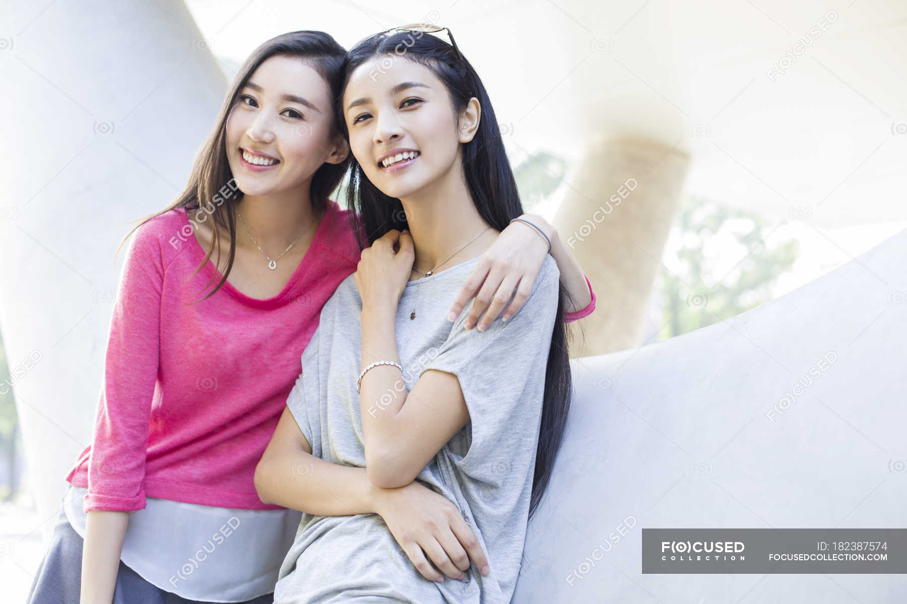 chinese-female-friends-posing-on-street-leisure-activity-summertime