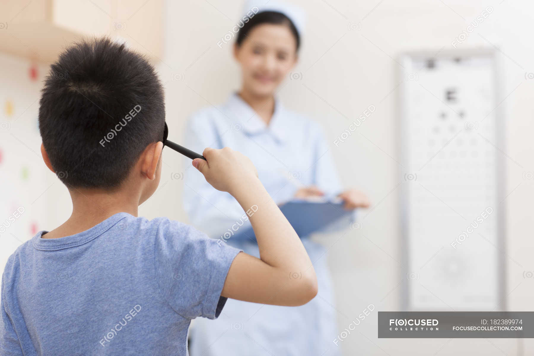 Chinese Boy Having Eye Exam Healthcare Worker Medical Equipment