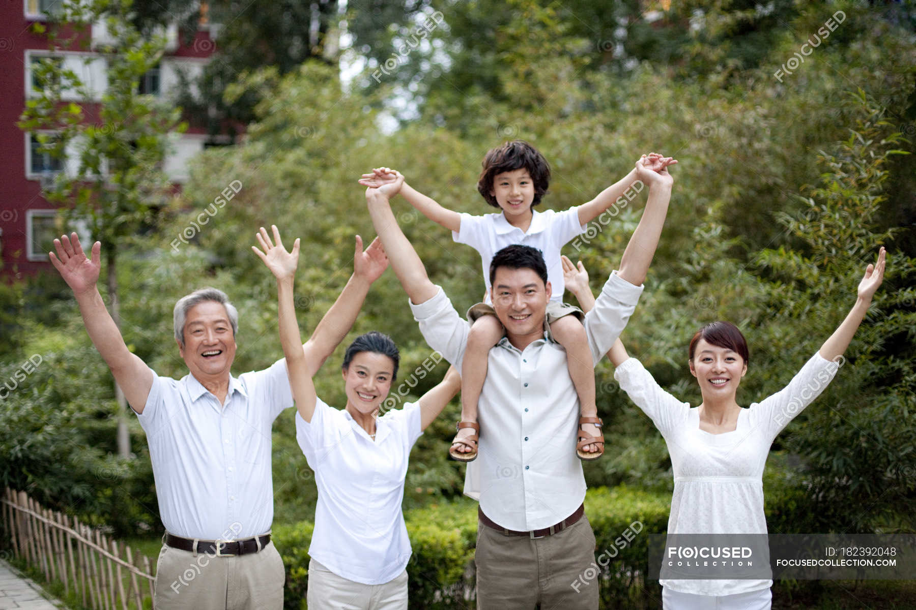 happy-chinese-family-posing-in-residential-district-cheerful