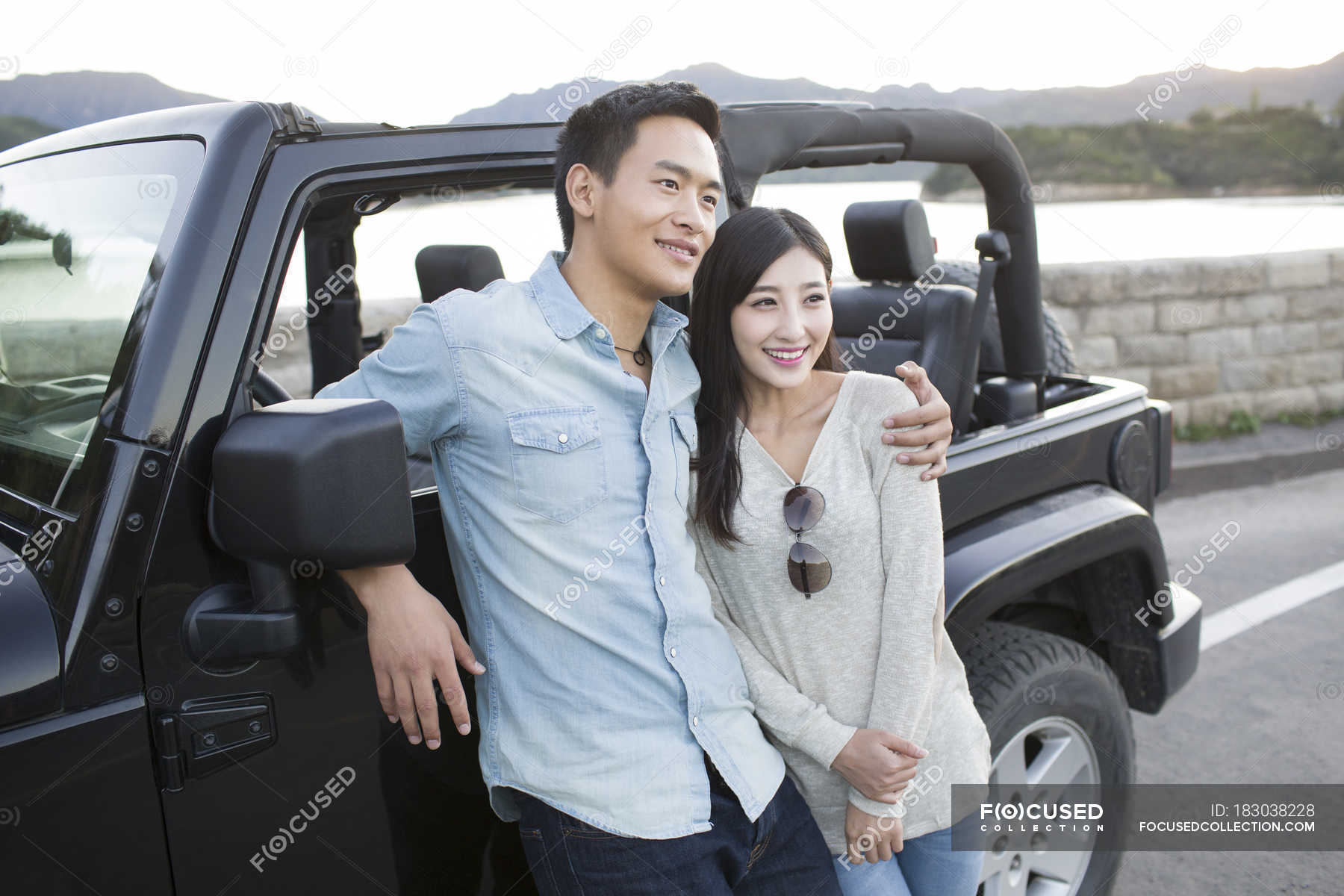 Chinese man hugging woman in front of car — Heterosexual Couple, china ...