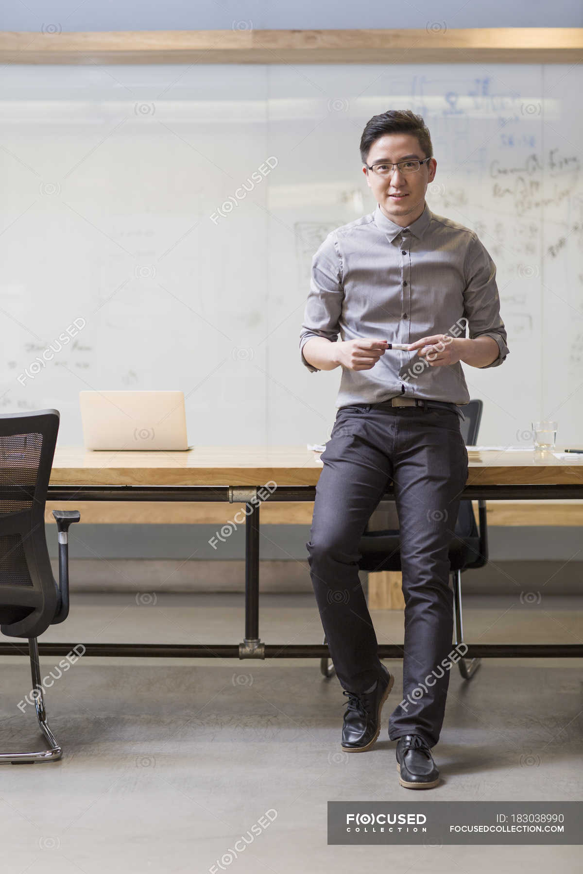 leaning against desk