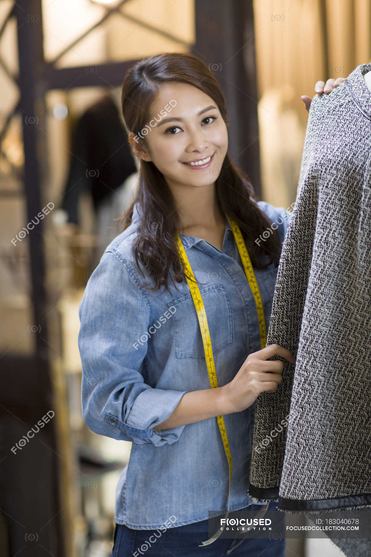 chinese-female-fashion-designer-standing-in-shop-woman-indoor-scene