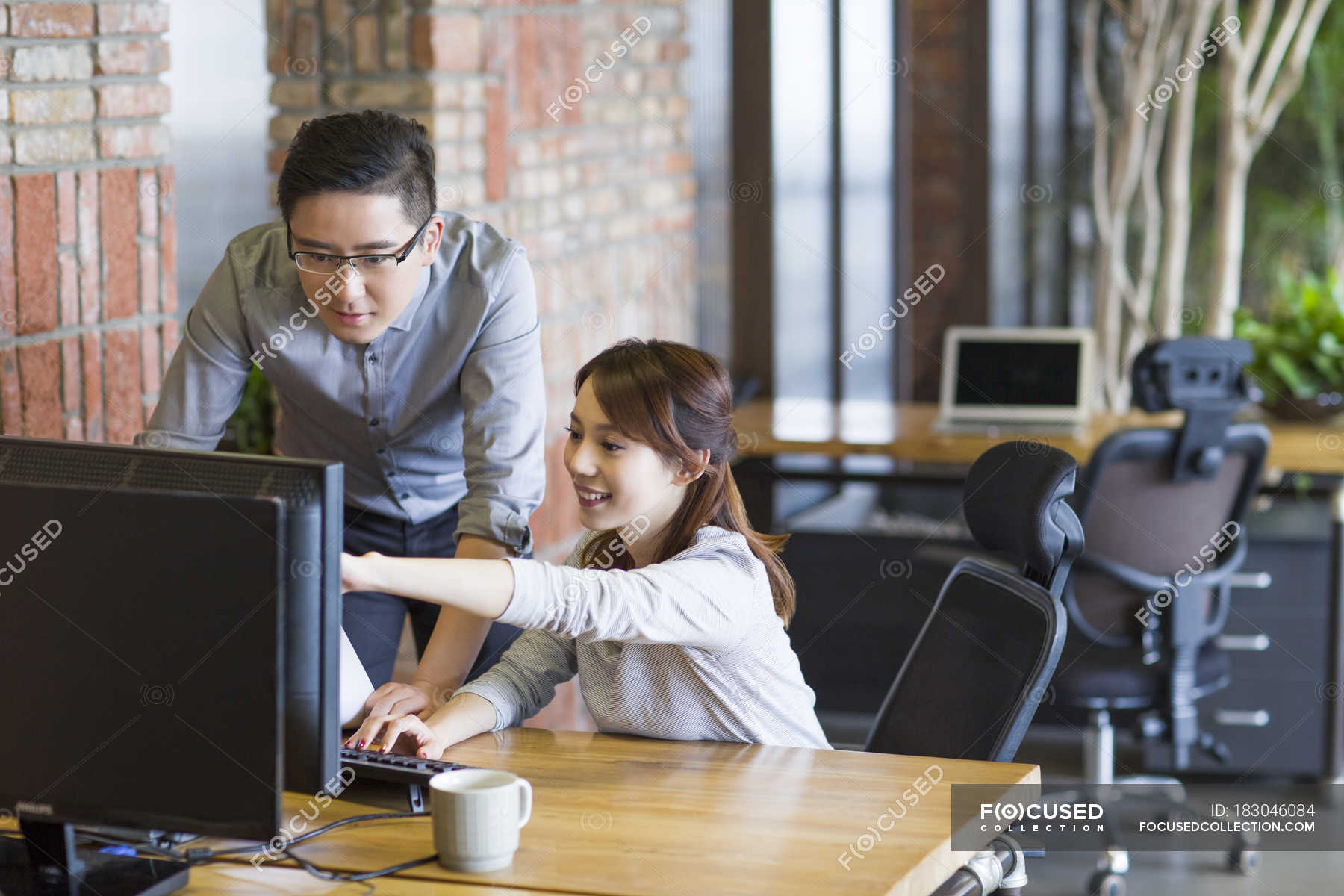 Chinese IT workers using computer in office — indoors, independence ...