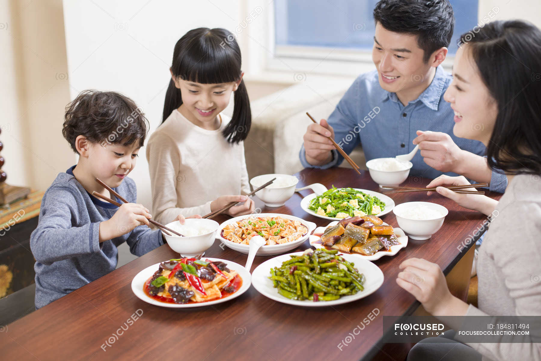 Chinese family eating at dining table together — Chinese culture