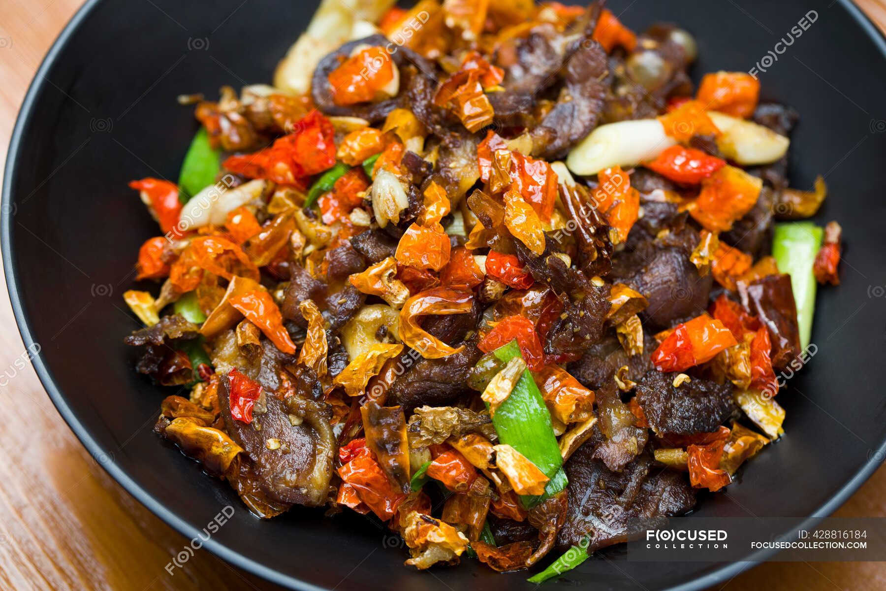 Chinese dish, spicy beef with chili peppers — delicious, close up ...