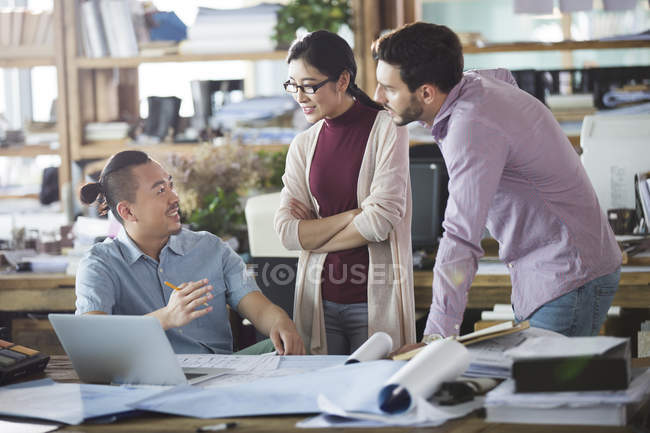 Architects talking in office and smiling — Stock Photo