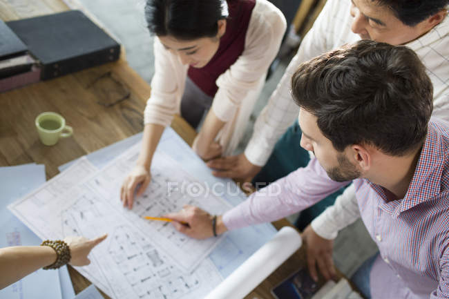 Architects working on blueprints in office — Stock Photo