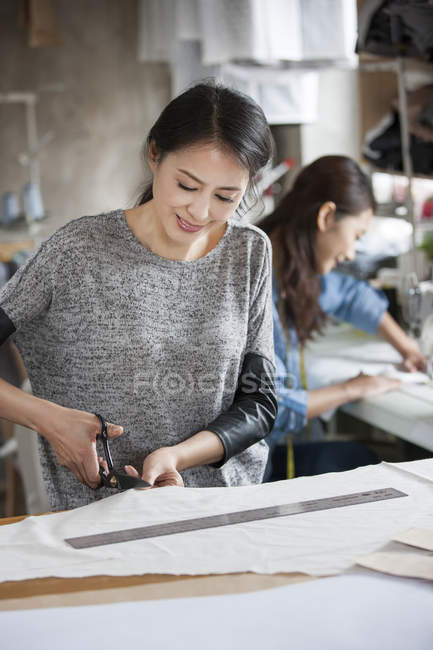 Chinese fashion designers working in studio — Stock Photo