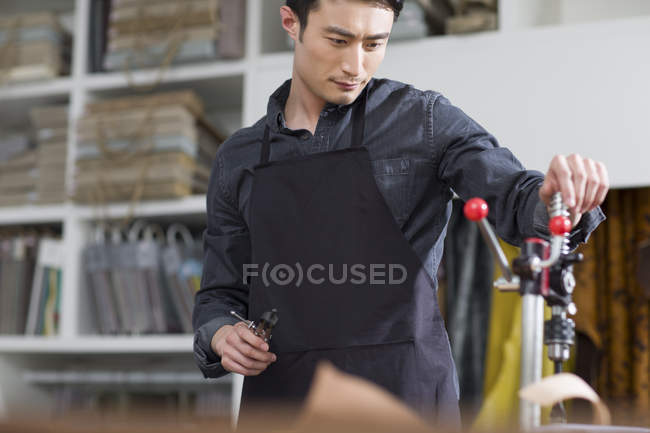 Asian male craftsman working in studio — Stock Photo